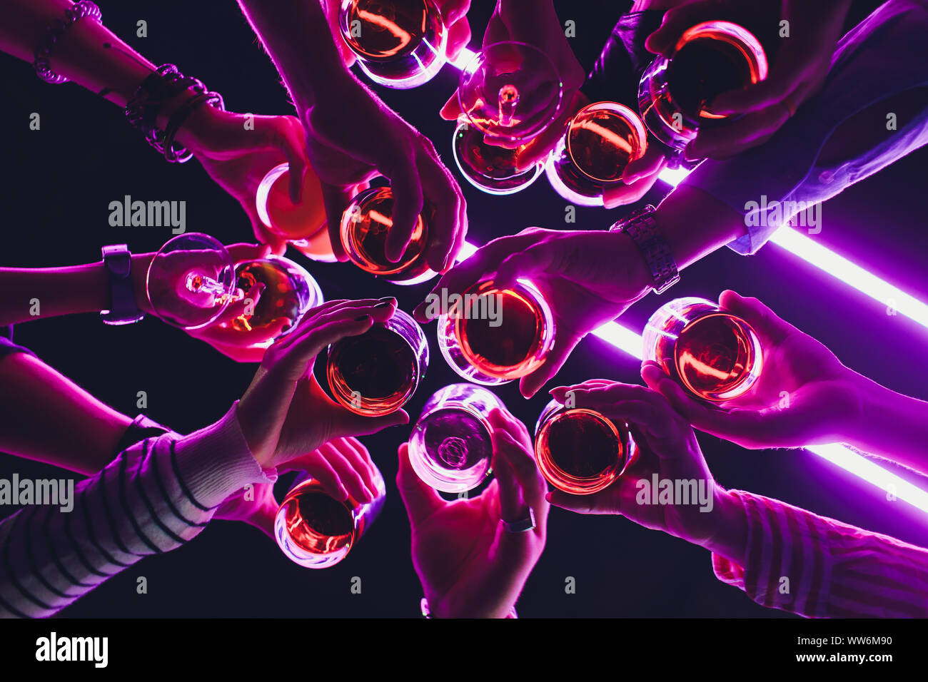 Clinking glasses with alcohol and toasting, party. Congratulations to