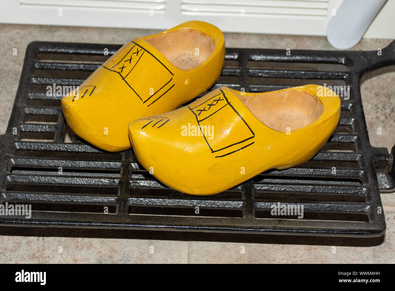 Small dutch wooden shoes on a shelf 