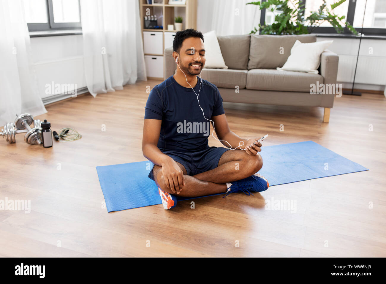 indian man meditating in lotus pose at home Stock Photo - Alamy