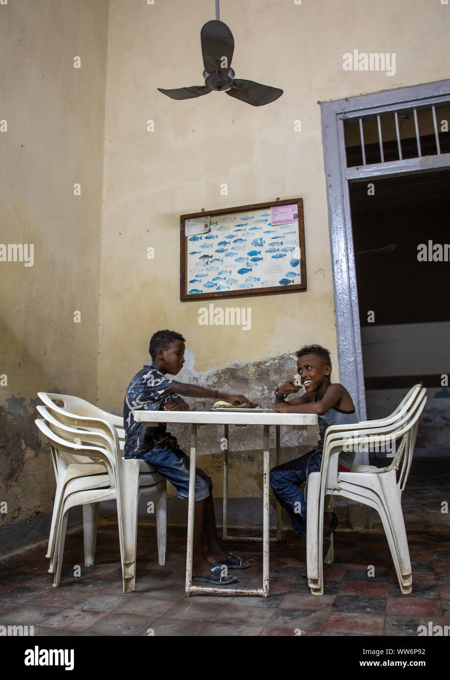 Children eating fish in selam restaurant, Northern Red Sea, Massawa, Eritrea Stock Photo