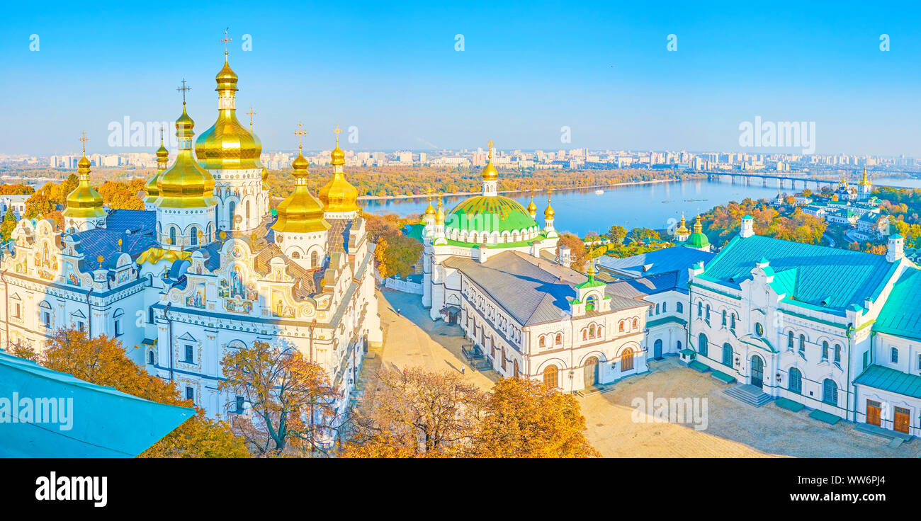 The courtyard of the medieval Kiev Pechersk Lavra complex with historical Dormition Cathedral anf small Refectory Church, Ukraine Stock Photo