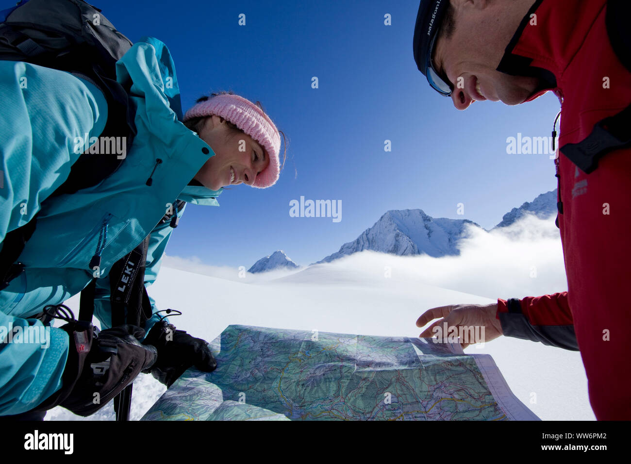Couple reading a map on a snowshoe tour to Gatterl, Wettersteingebirge, Tyrol, Austria Stock Photo
