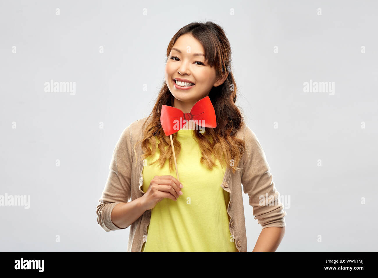 happy asian woman with big red bow tie Stock Photo