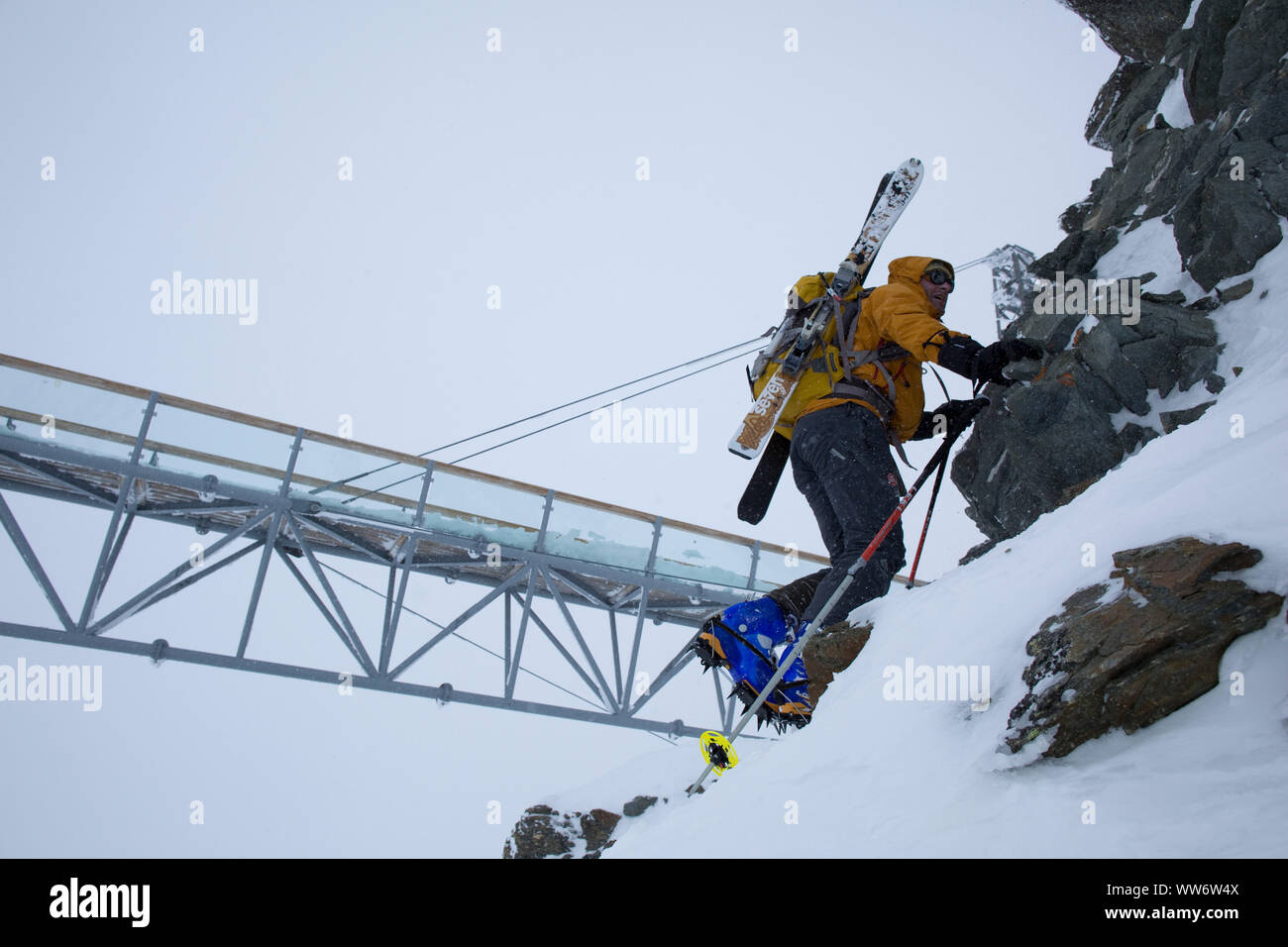 Climber climbs with touring skis at Tiefenbachjoch in winter, Ã–tztaler Alps, Tyrol, Austria. Stock Photo