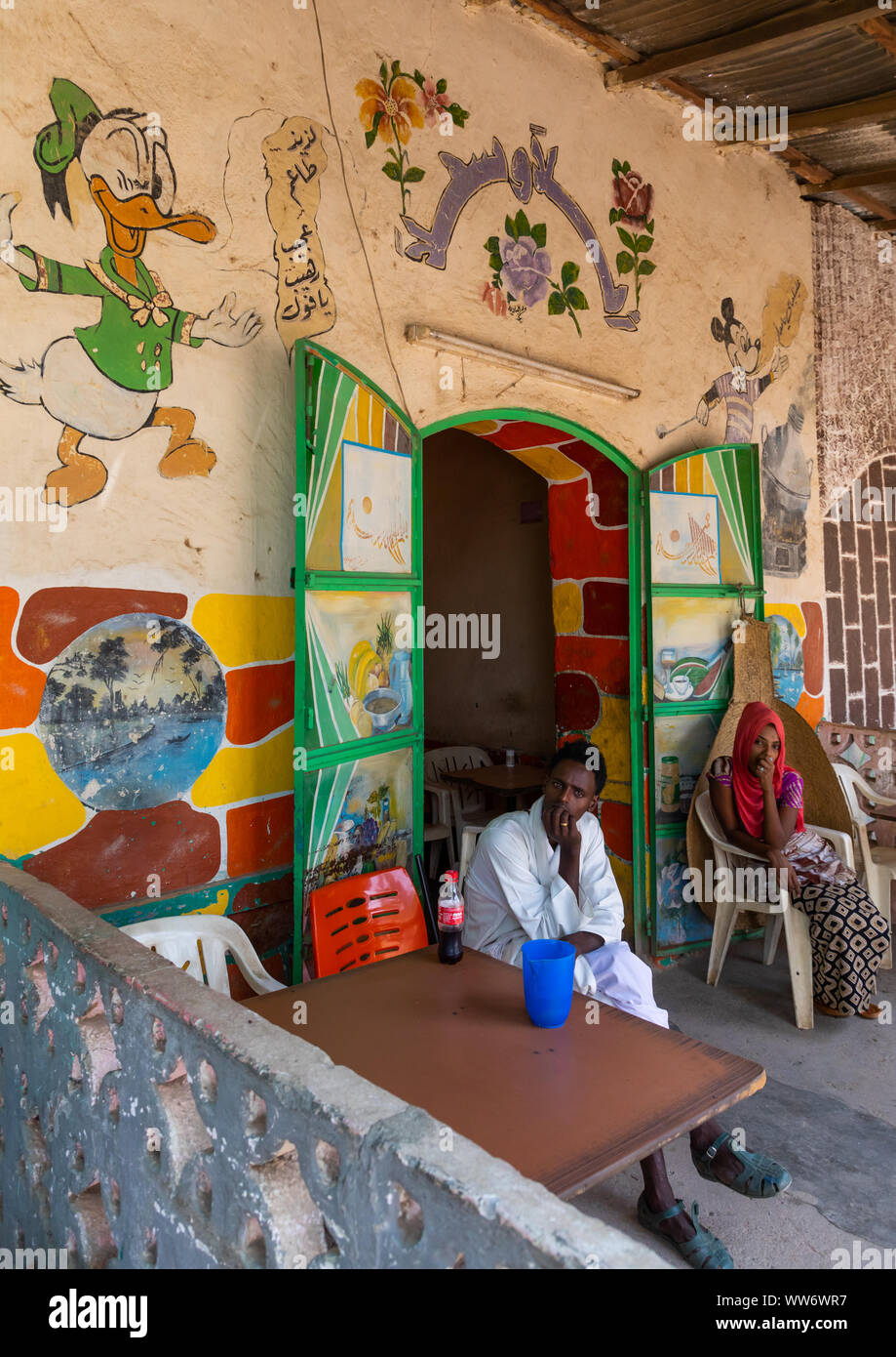 Eritrean people in a bar decorated with disney characters, Gash-Barka, Agordat, Eritrea Stock Photo