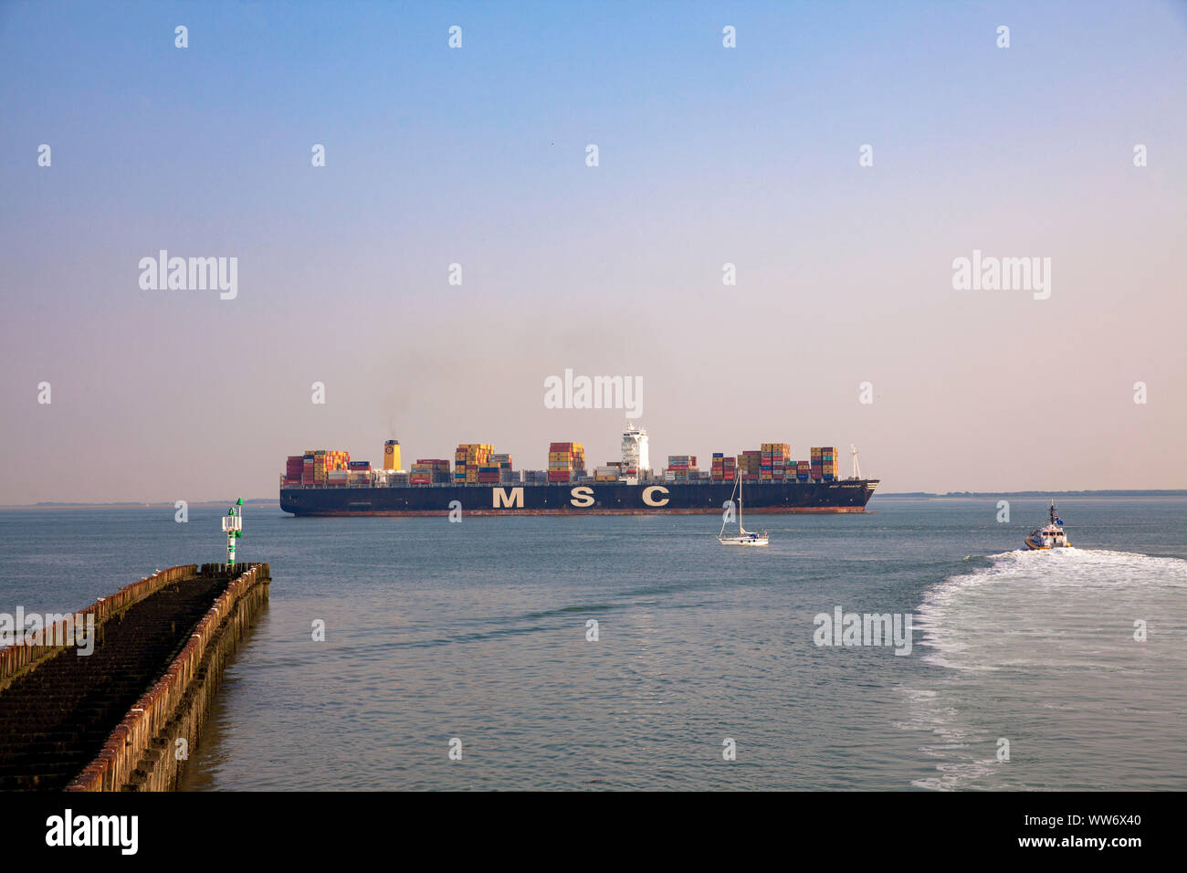 container ship on the Western Scheldt off the coast of Vlissingen, Walcheren, Zeeland, Netherlands.  Containerschiff auf der Westerschelde vor Vlissin Stock Photo