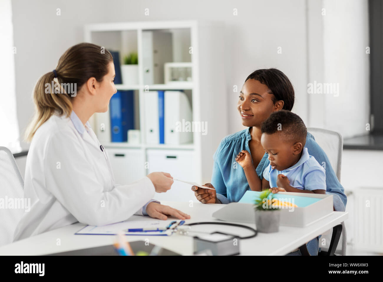 happy mother with baby son and doctor at clinic Stock Photo - Alamy