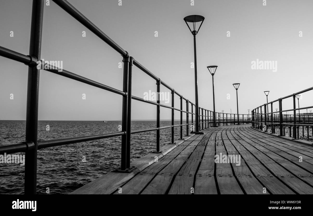 A black and white picture of a pier in the grand promenade of Limassol. Stock Photo