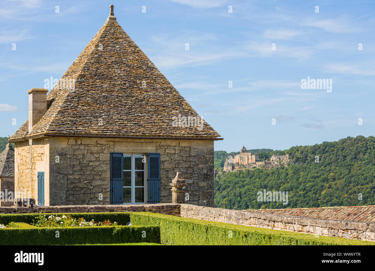 Topiary in the gardens of the Jardins de Marqueyssac in the Dordogne region of France. Castle of Castelnaud on the back. Stock Photo