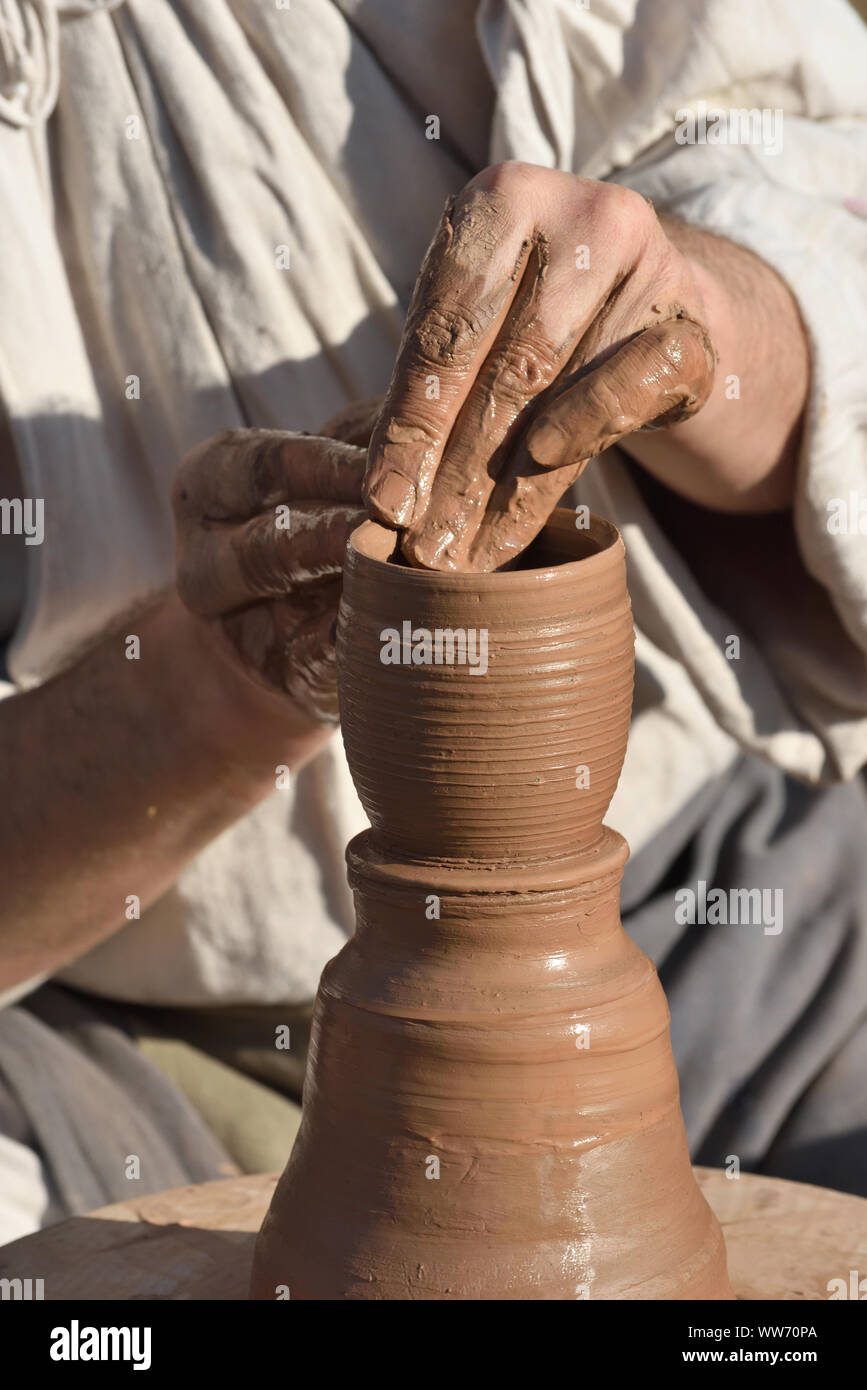 Pottery male ceramist creates a hand made clay product. Process of
