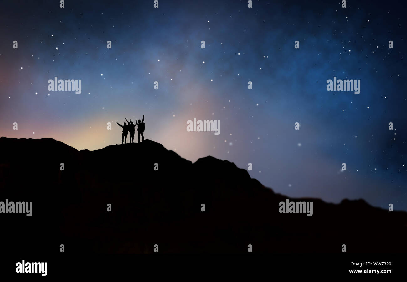 Travelers Celebrating Success Over Night Sky Stock Photo Alamy