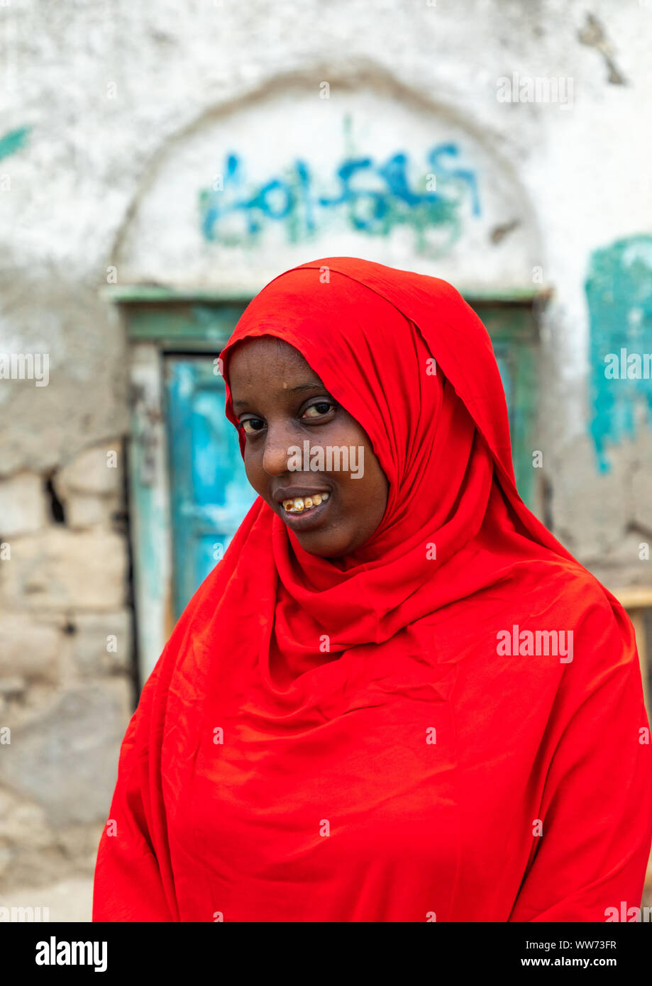 Portrait of a somali woman in red hijab in the streets of the old town, Sahil region, Berbera, Somaliland Stock Photo