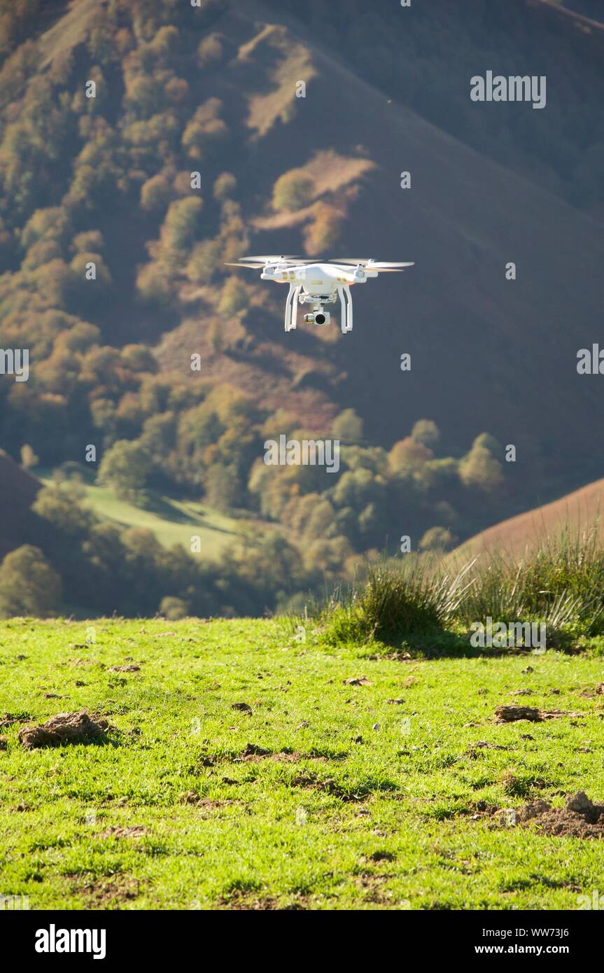 A drone flying in mountains in summer Stock Photo