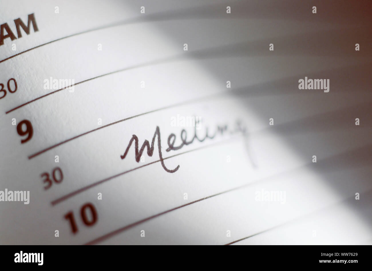 Page of an Appointment book with the word, "Meeting" written in it. Stock Photo