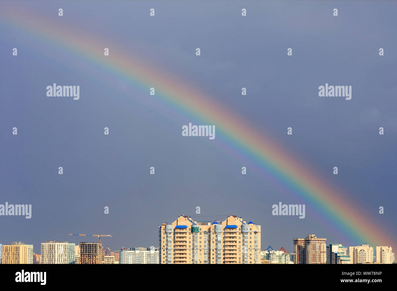 Bright rainbow in the sky above urban houses after a thunderstorm Stock ...