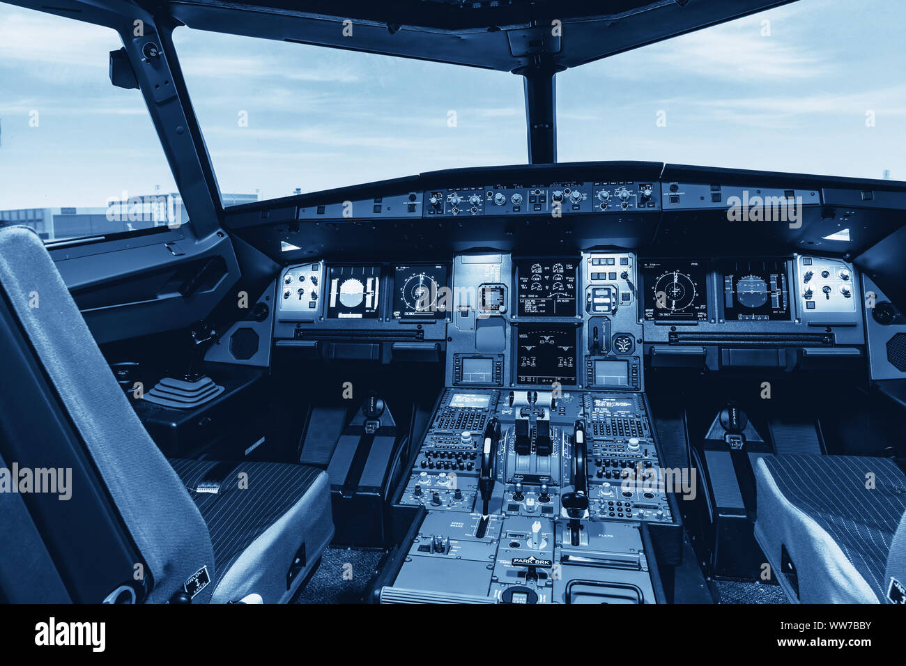 Cockpit of airliner simulator. Switches and dials visible in the background  Stock Photo - Alamy