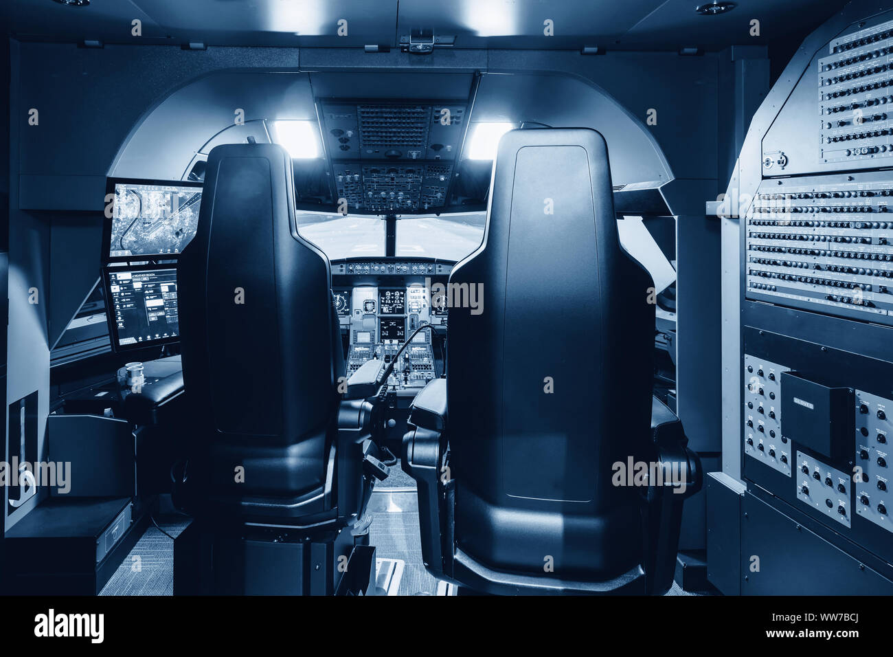 Cabin of a large airliner simulator. View of the cockpit and seats in the A320 airbus simulator. Stock Photo