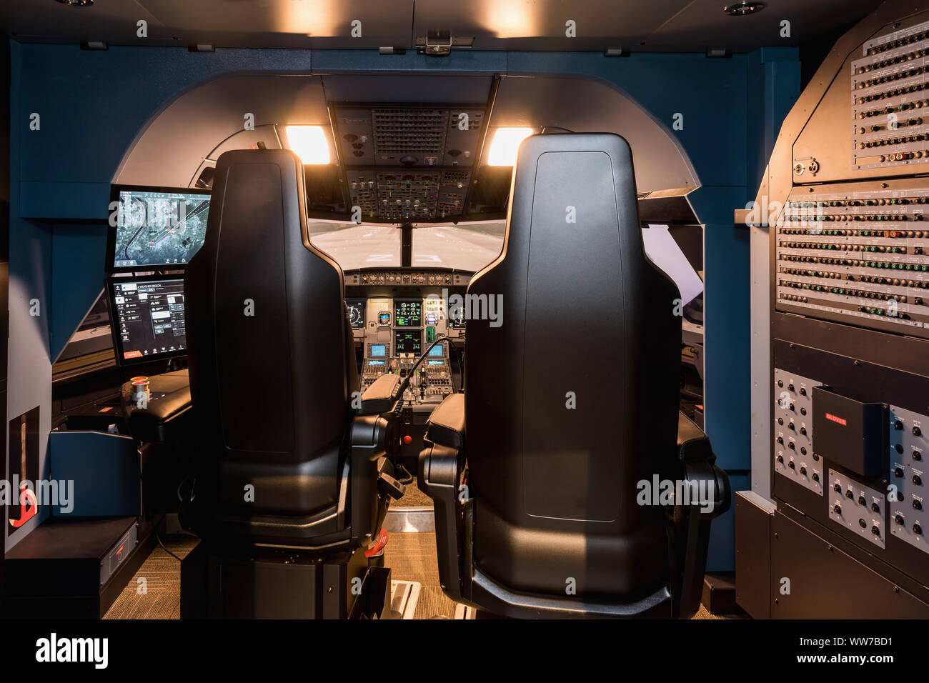 Cabin of a large airliner simulator. View of the cockpit and seats in the A320 airbus simulator. Stock Photo