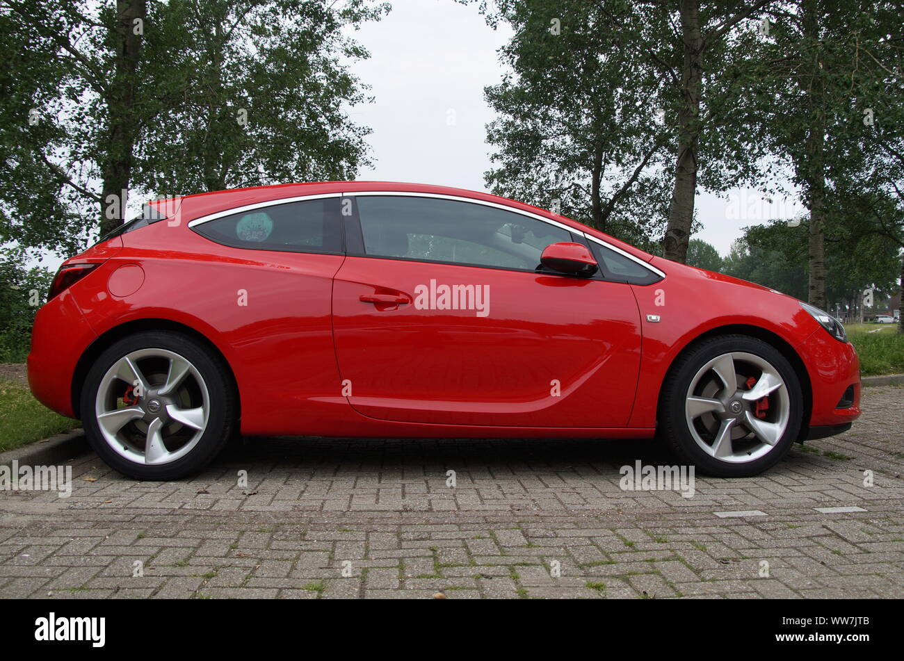 Almere, The Netherlands - May 29, 2016: Red Opel Astra GTC parked on a public parking lot Stock Photo