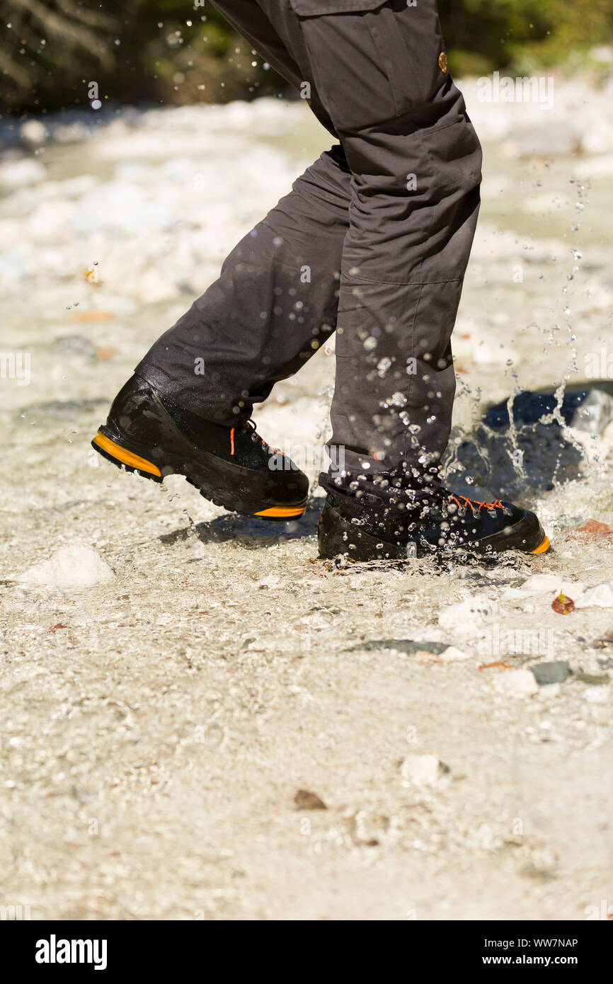 Berchtesgaden, Alps, hikers crossing mountain brook, detail, legs, shoes, water splashing, Stock Photo