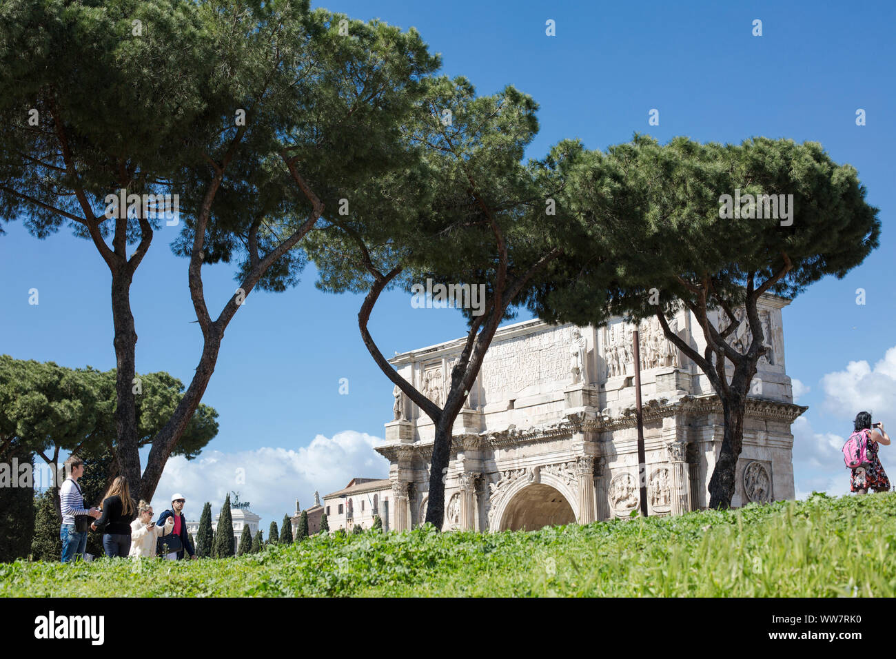Italy, Rome, people walking along a way to the Coliseum, in the background Meta Sudans Stock Photo