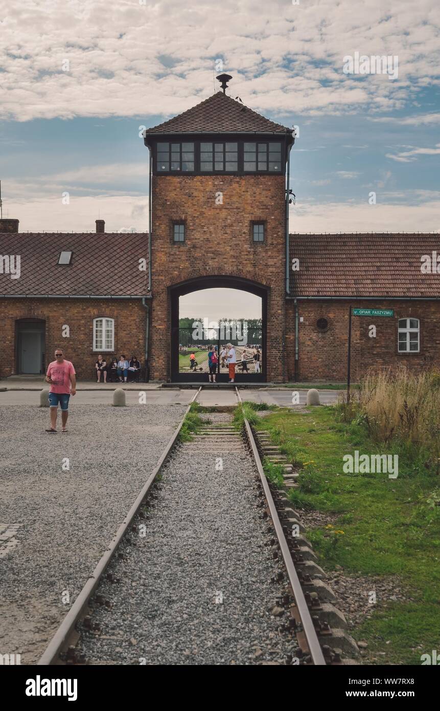 OSWIECIM, POLAND - AUGUST 17, 2019: The main gate to the concentration camp Auschwitz Birkenau in Oswiecim, Poland. Stock Photo