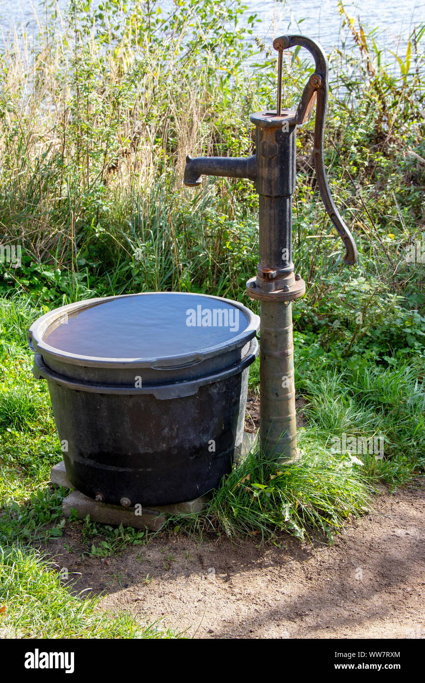 old mechanical castiron piston pump in the garden Stock Photo Alamy