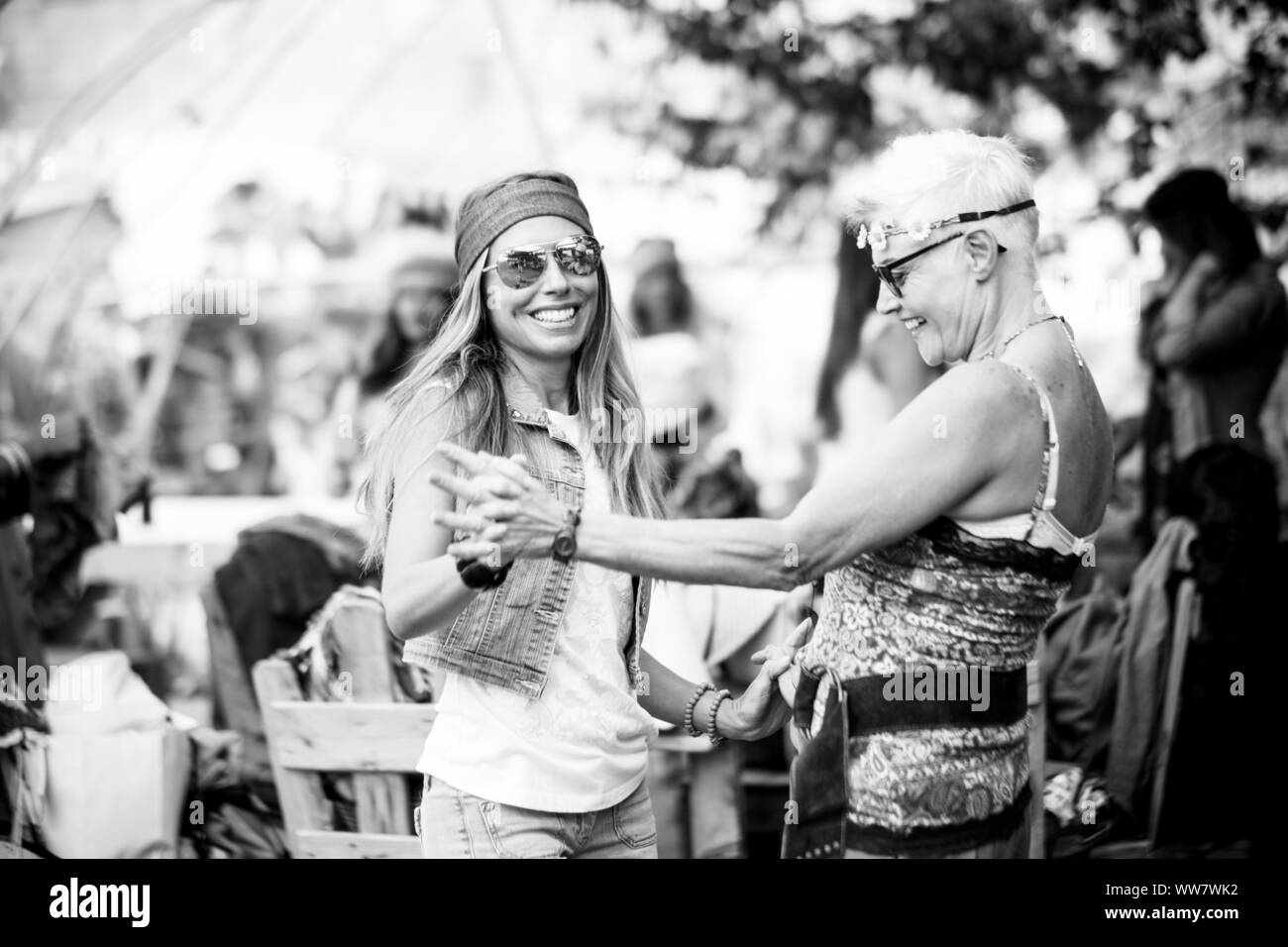 young women and girls in friendship all together celebrating and having fun in a bio natural place. smiles and laughing for group of hippies people alternative concept lifestyle Stock Photo