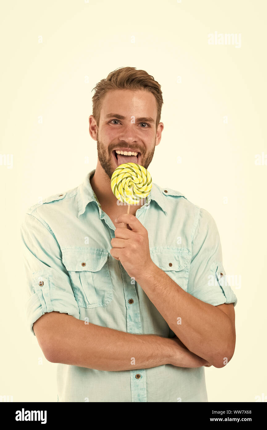 Lick it. Man handsome bearded guy smiling while licking candy. Guy cheerful  smile macho feels happy and satisfied. Positive emotions. Sweet taste. Hea  Stock Photo - Alamy