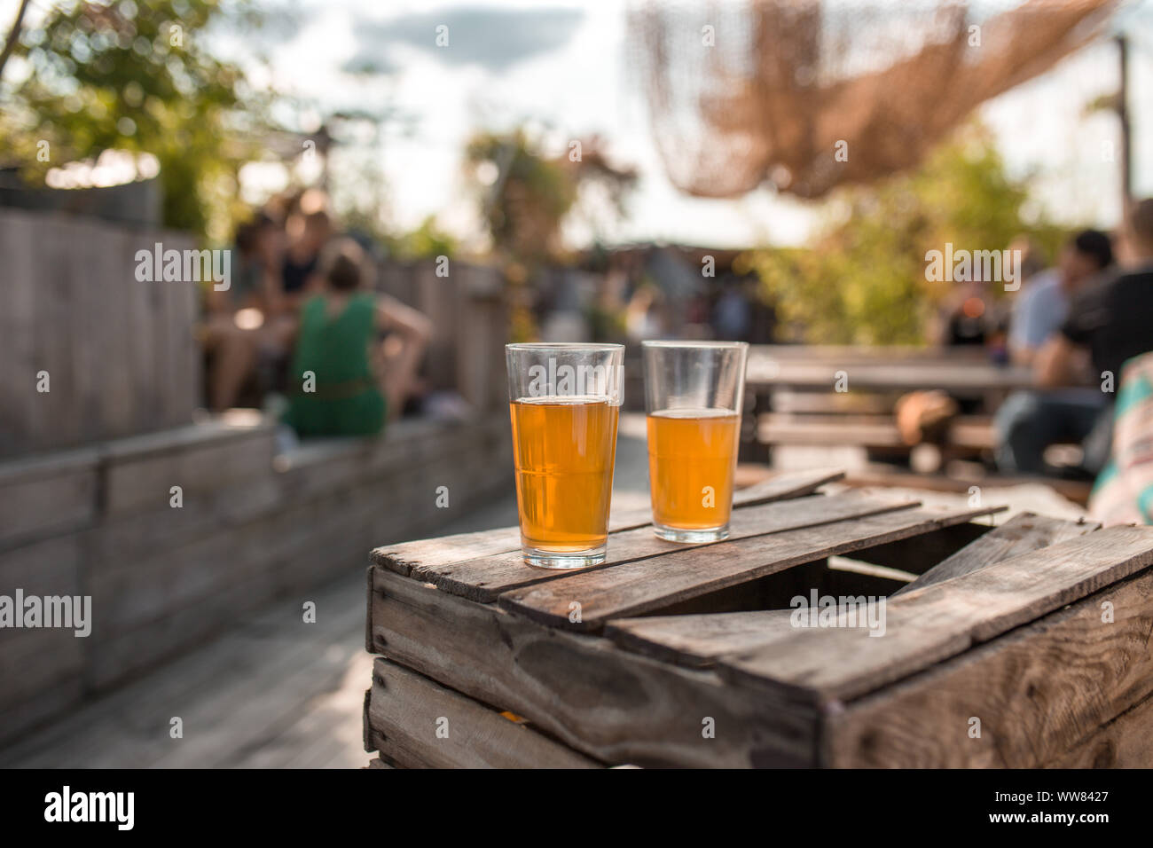 Two glasses of tea on broken wooden table at dachgarten in Munich Stock Photo