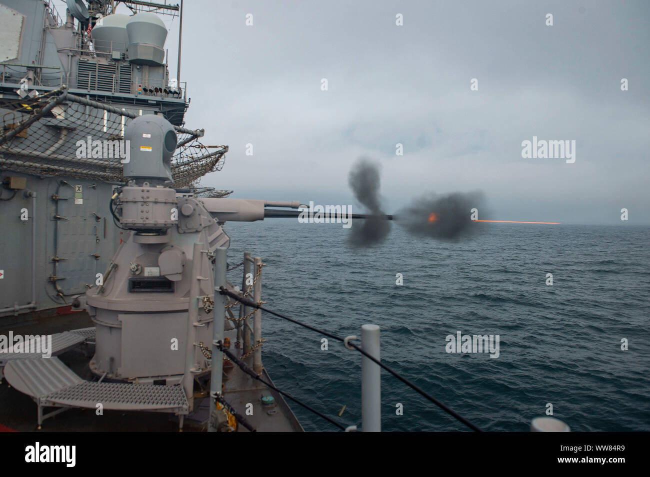 190909-N-DV626-0167  ATLANTIC OCEAN (Sept. 9, 2019) The Ticonderoga-class guided-missile cruiser USS Vella Gulf (CG 72) fires its 25mm weapons system from a weather deck during a Surface Warfare Advanced Tactical Training (SWATT) exercise with other U.S. Navy warships. Surface Warships assigned to the Eisenhower Carrier Strike Group are participating in the exercise in the Atlantic Ocean, off the coast of Florida, to maintain readiness, proficiency and lethality. (U.S. Navy photo by Mass Communication Specialist 3rd Class Gian Prabhudas) Stock Photo