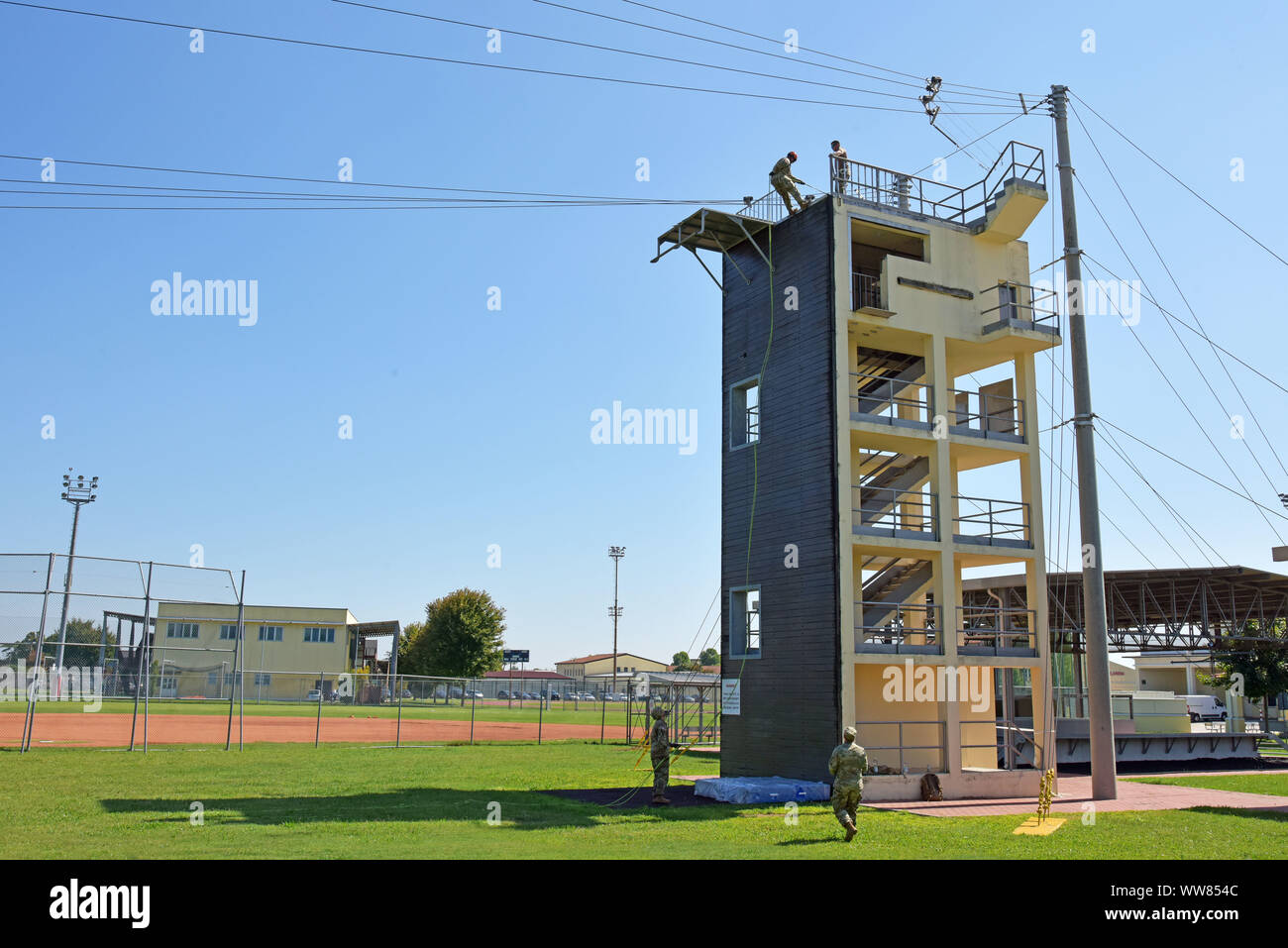 Soldiers from U.S. Army Africa conduct rappel training on the 7th Army Training Command-constructed jump tower, the only Army jump tower in Europe, at Caserma Ederle in Vicenza, Italy, Sept. 12, 2019. Soldiers rappel from the 34-foot-tall tower wearing a safety harness, helmet and gloves to gain confidence. (U.S. Army photo by Paolo Bovo) Stock Photo