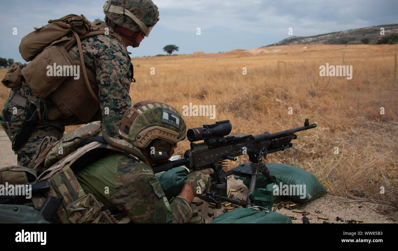 A Spanish Soldier fires an M240B medium machine gun during a bilateral exercise in Ronda, Spain, Sept. 4, 2019. U.S. Marines with Special Purpose Marine Air-Ground Task Force-Crisis Response-Africa 19.2, Marine Forces Europe and Africa, trained alongside their Spanish counterparts to increase proficiency as a crisis response force and enhance bilateral interoperability with their allies. SPMAGTF-CR-AF is deployed to conduct crisis-response and theater-security operations in Africa and promote regional stability by conducting military-to-military training exercises throughout Europe and Africa. Stock Photo