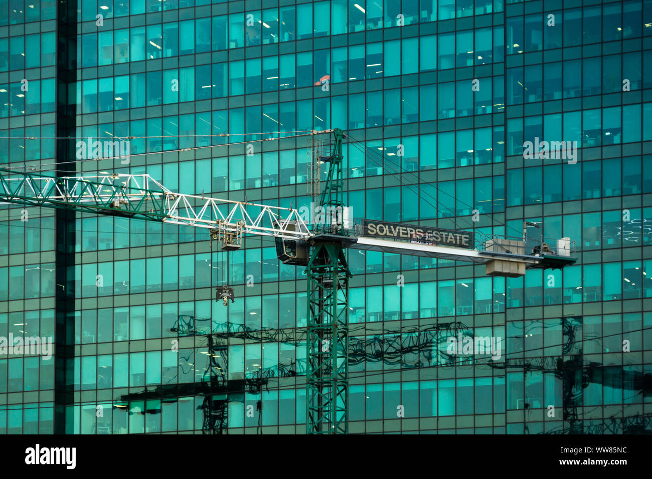 Moscow, Russia - September 12, 2019: Tower construction cranes on the background of glass facades of the buildings of the Moscow City business center Stock Photo