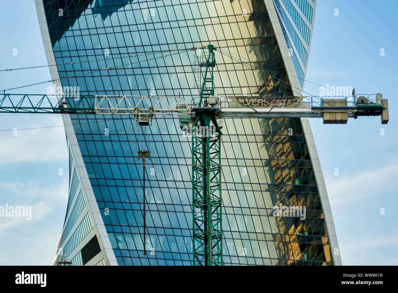 Moscow, Russia - September 12, 2019: Tower construction cranes on the background of glass facades of the buildings of the Moscow City business center Stock Photo