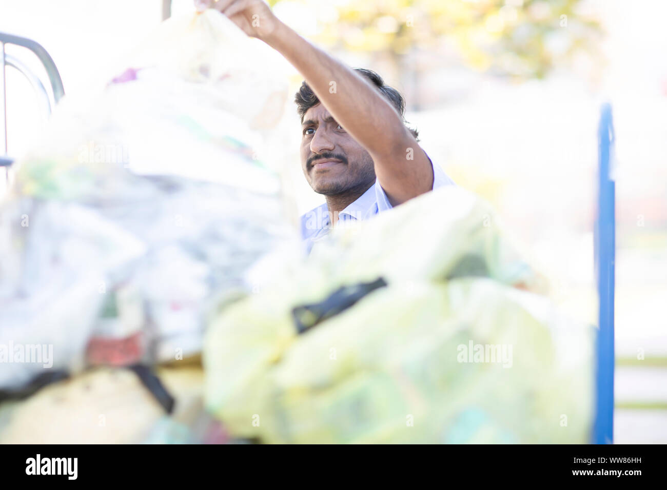 young man with bin liner Stock Photo