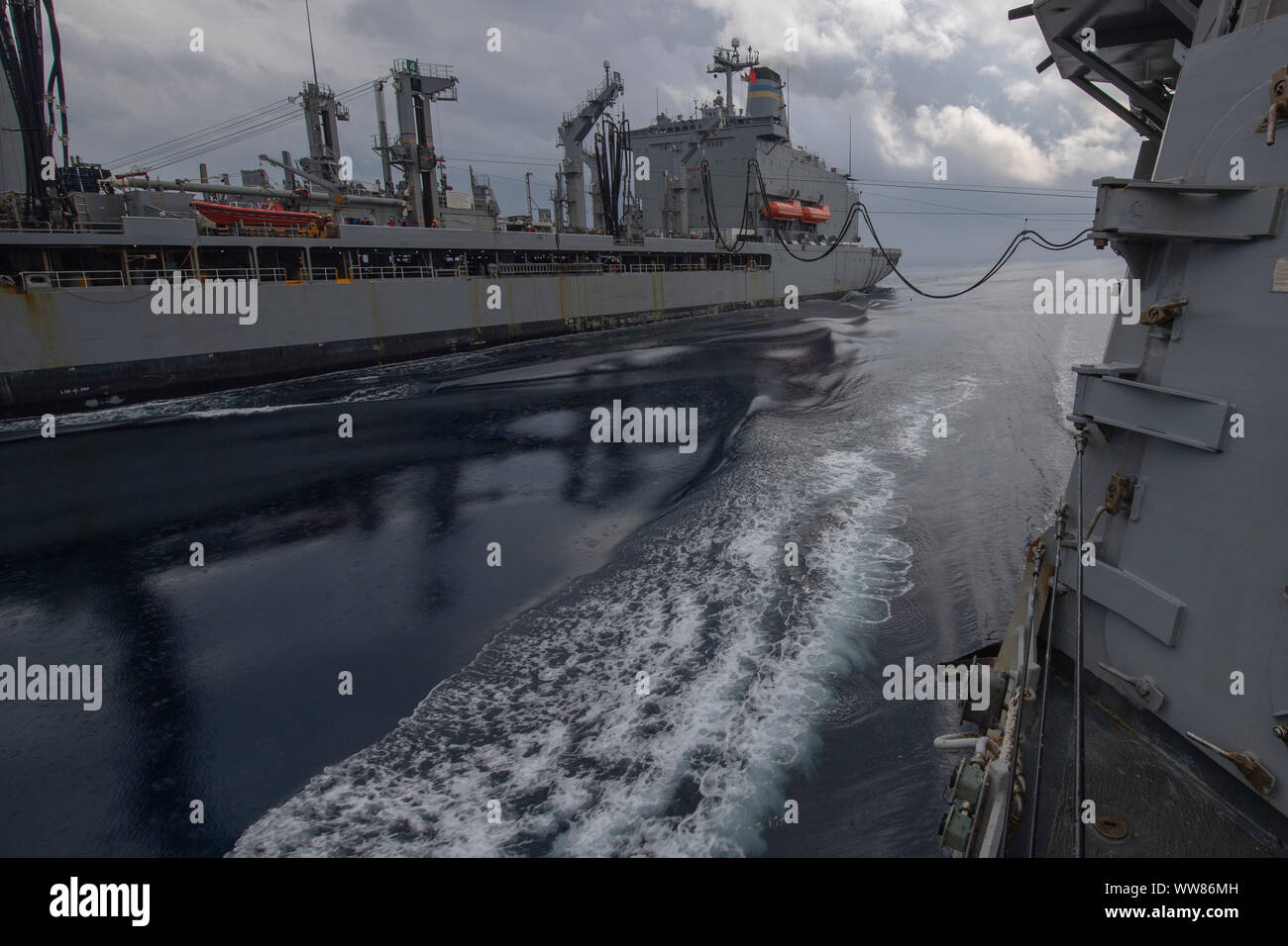 190910-N-RH019-0031 YELLOW SEA (Sep. 31, 2019) The Arleigh Burke-class guided-missile destroyer USS Momsen (DDG 92) conducts a replenishment-at-sea with the fleet replenishment oiler USNS Pecos (T-AO 197). Momsen is deployed to the U.S. 7th Fleet area of operations in support of security and stability in the Indo-Pacific region (U.S. Navy photo by Mass Communication Specialist 2nd Class Sean Rinner/Released) Stock Photo