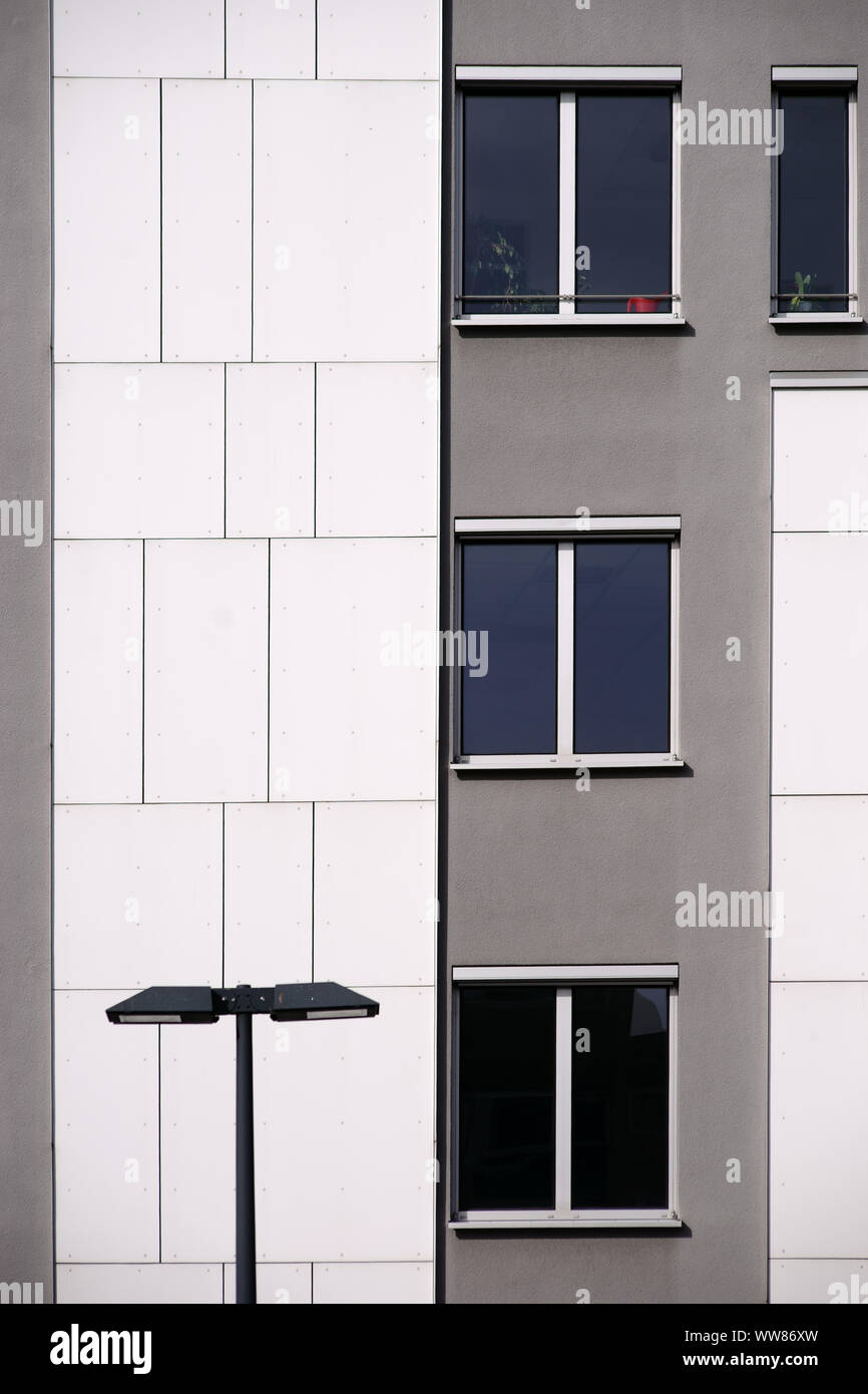 A lantern in front of a modern house facade with grey and white wall covering Stock Photo