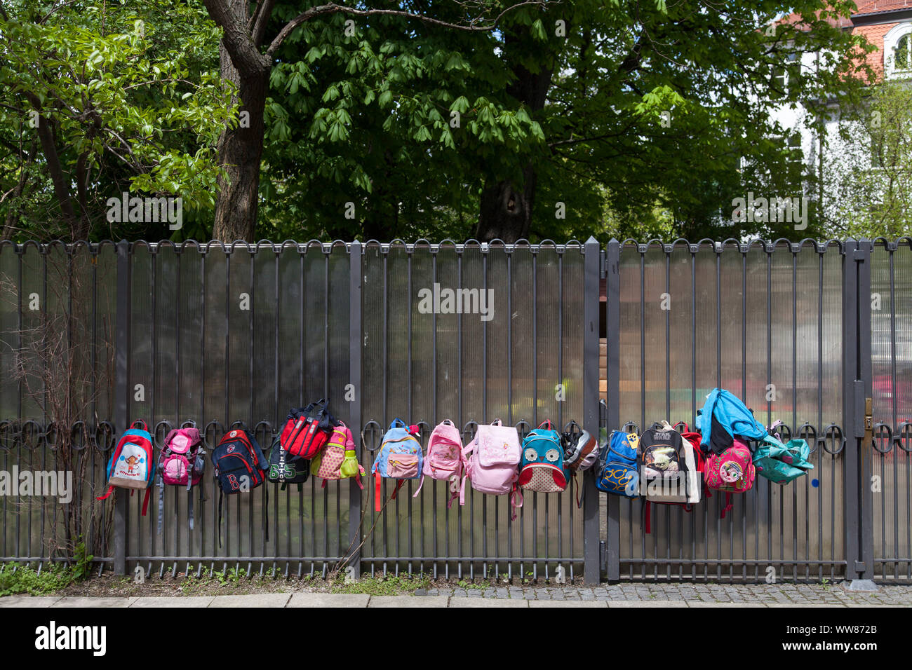 15 child backpacks at court gate Stock Photo