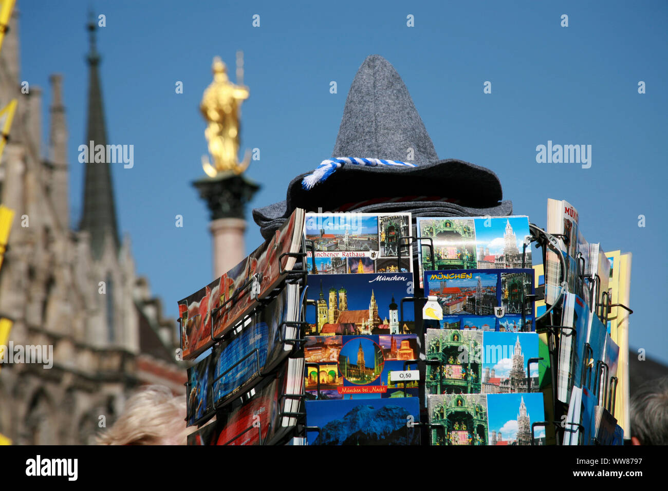 Postcard rack with Bavarian felt hat in front of Munich Marian column Stock Photo