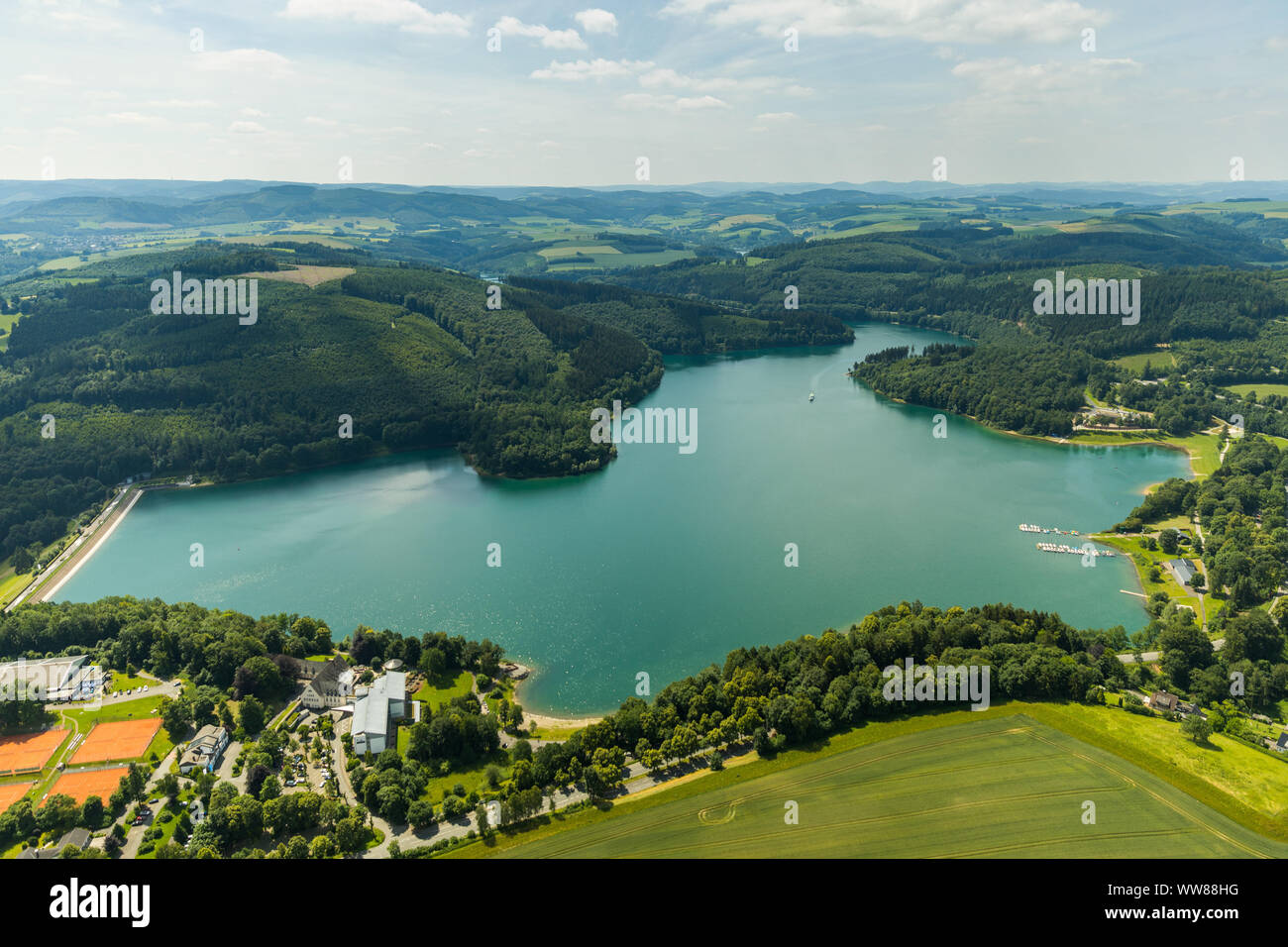 Aerial view, Hennesee with WELCOME HOTEL MESCHEDE / HENNESEE and jetty of MS Hennesee, tennis courts Tennisclub Meschede 1909 e.V., Meschede, Sauerland, North Rhine-Westphalia, Germany Stock Photo