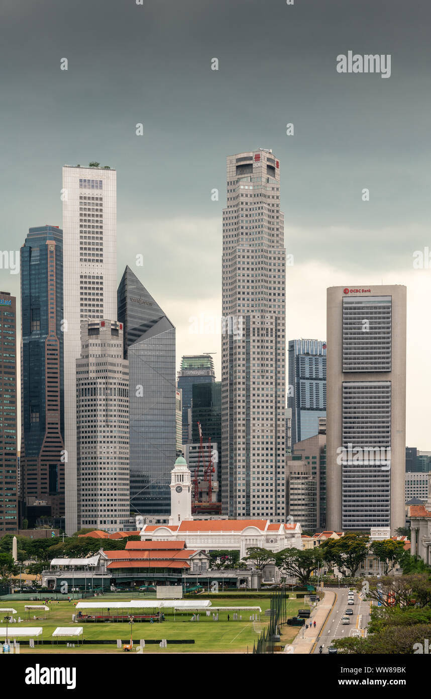 Singapore - March 20, 2019: Partial portrait of financial district skyscrapers from Capitaland to OCBC Bank buildings under dark gray cloudscape. Vict Stock Photo