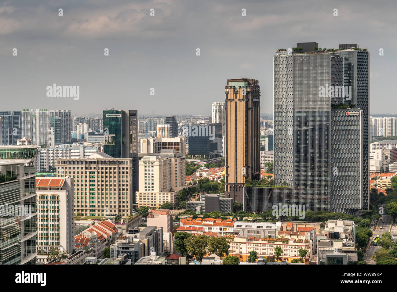 Singapore - March 20, 2019: Shot over hundreds of skyscrapers under heavy cloudy sky. Centered on Raffles Hospital and Andaz tower by Hyatt. Smaller b Stock Photo