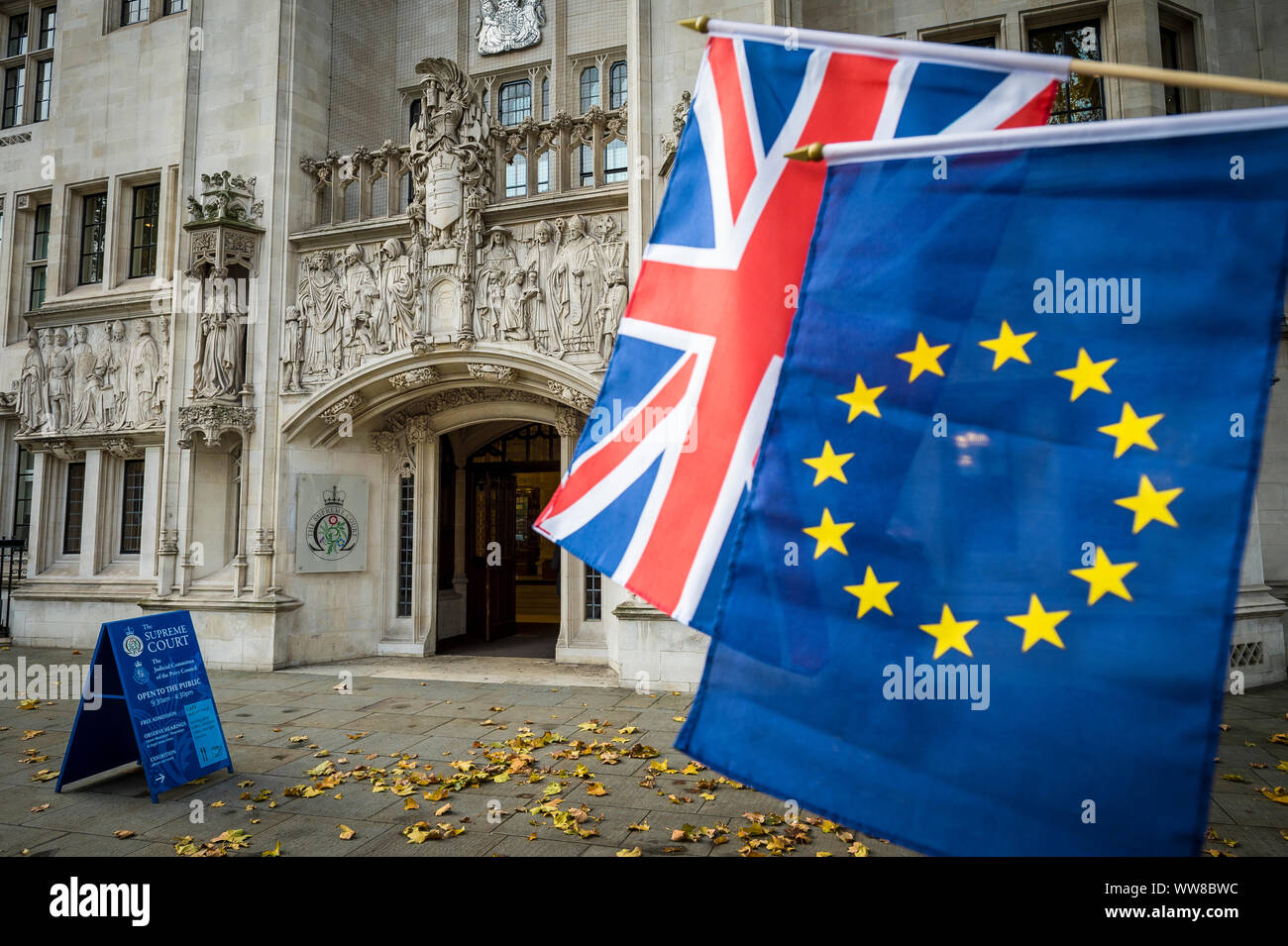 LONDON - DECEMBER 5, 2016: EU and UK flags hang outside the Supreme Court of the United Kingdom in Parliament Square. Stock Photo