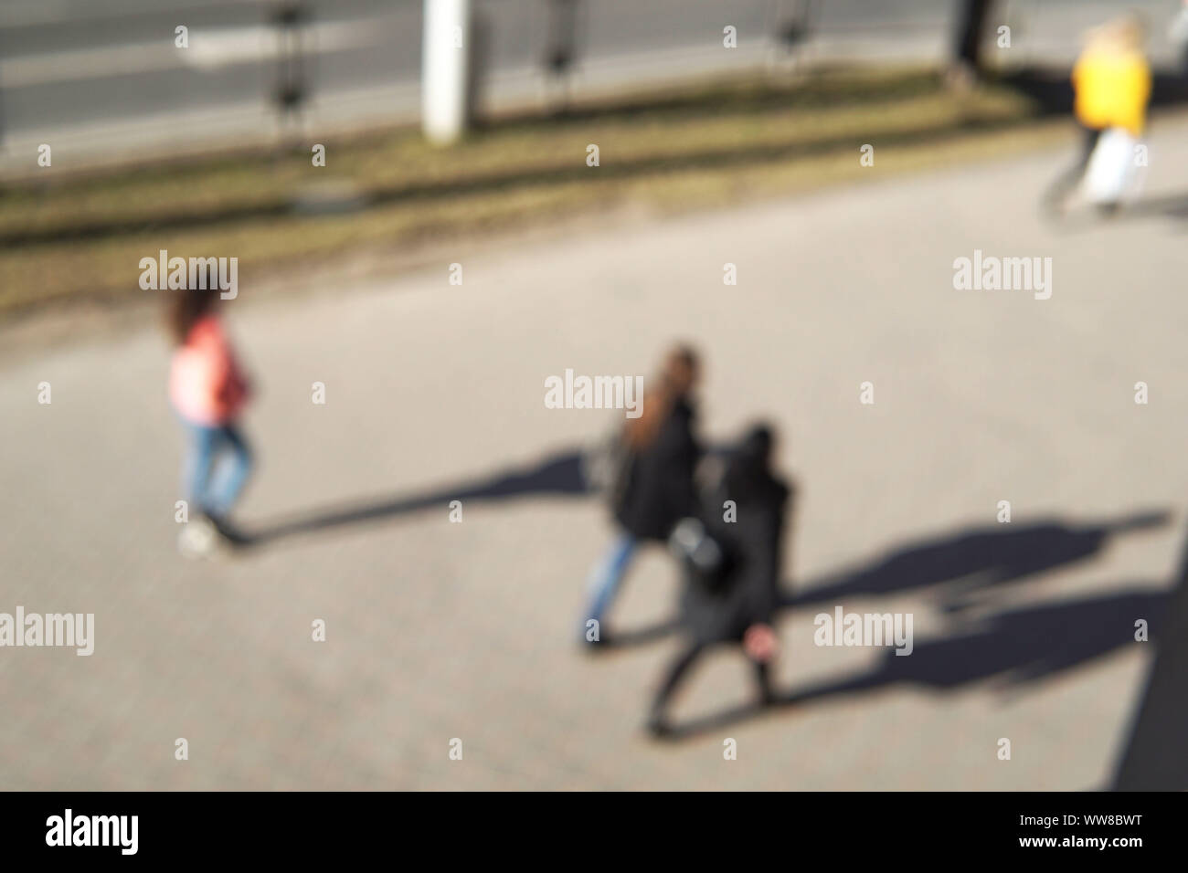 Blurred image of young people on the street. Top view. Stock Photo
