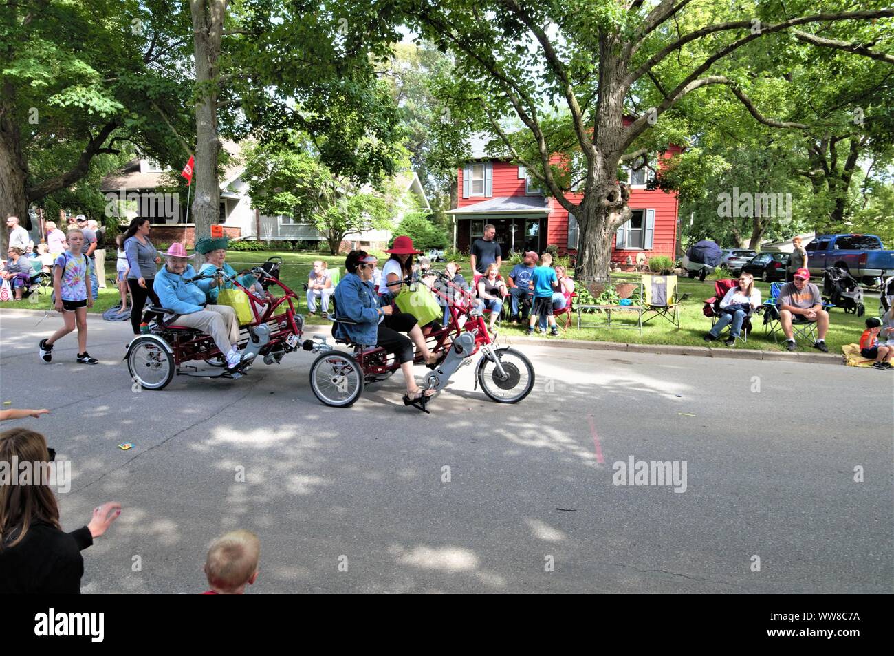Elderly People Riding Tricycles in Small-Town America Parade Stock Photo