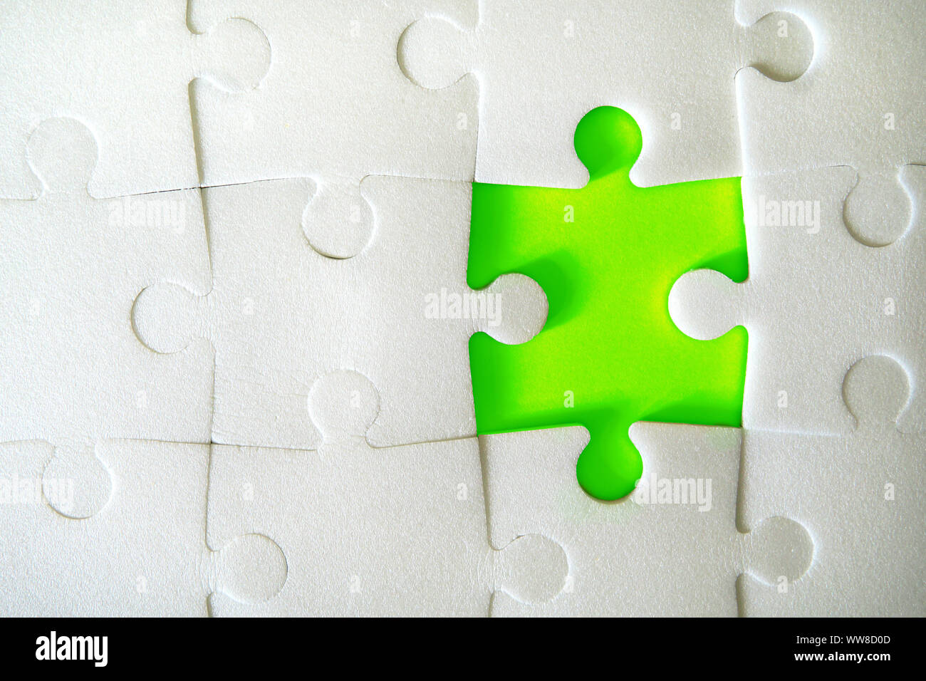 Multiple white puzzle pieces put together without one piece. View from above. Close up image. Stock Photo