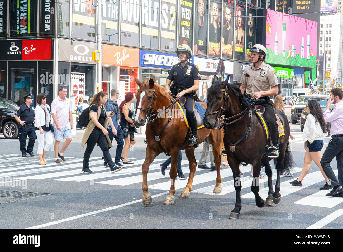 Two Police Officers can be seen on horses in Time Square, New York City ...