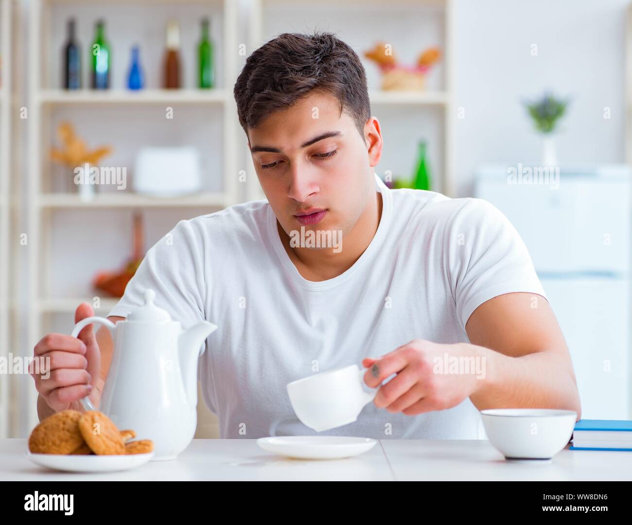 The man falling asleep during his breakfast after overtime work Stock Photo