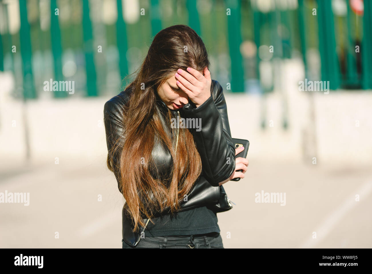Sad girl feeling upset receiving bad news in mobile message on ...